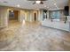 Open concept living area with tile flooring and kitchen access at 13049 W Redbird Rd, Peoria, AZ 85383