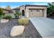 Single-story home with attached garage and desert landscaping at 13049 W Redbird Rd, Peoria, AZ 85383