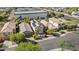 Aerial view of houses, street and a large building in the background at 3211 E Kerry Ln, Phoenix, AZ 85050