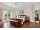 Bright main bedroom with wood flooring, a king-size bed, and access to a private balcony at 26348 N 104Th Way, Scottsdale, AZ 85255
