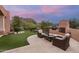 Landscaped backyard with patio furniture and fire pit at 26348 N 104Th Way, Scottsdale, AZ 85255
