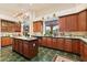 Large kitchen with island, green tile floors, and wood cabinets at 26348 N 104Th Way, Scottsdale, AZ 85255