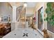 Grand entryway with a curved staircase, high ceilings, and elegant tile flooring at 26348 N 104Th Way, Scottsdale, AZ 85255