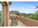 Private balcony with mountain views, featuring wrought iron chairs and a tranquil setting at 26348 N 104Th Way, Scottsdale, AZ 85255