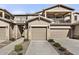 Two-story townhome with attached garage and a walkway leading to the entrance at 2140 W Tallgrass Trl # 208, Phoenix, AZ 85085