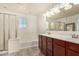 Main bathroom with double vanity, soaking tub, and shower at 7311 N 90Th Ave, Glendale, AZ 85305