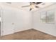 Well-lit bedroom with ceiling fan and window coverings at 7311 N 90Th Ave, Glendale, AZ 85305