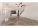 Open concept living room with kitchen and staircase at 7311 N 90Th Ave, Glendale, AZ 85305