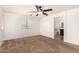 Spacious bedroom with ceiling fan and plush carpeting at 7311 N 90Th Ave, Glendale, AZ 85305