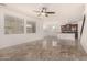 Open floorplan living room with kitchen island and tile flooring at 7311 N 90Th Ave, Glendale, AZ 85305