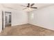 Bright bedroom with ceiling fan and carpet flooring at 7311 N 90Th Ave, Glendale, AZ 85305