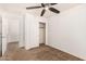 Bright bedroom with ceiling fan, carpet, and ample closet space at 7311 N 90Th Ave, Glendale, AZ 85305