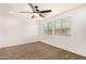 Spacious bedroom featuring a ceiling fan and large windows at 7311 N 90Th Ave, Glendale, AZ 85305