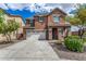 Two-story house with a large driveway and landscaping at 7311 N 90Th Ave, Glendale, AZ 85305