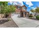 Two-story house with a large driveway and landscaping at 7311 N 90Th Ave, Glendale, AZ 85305