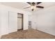Bright bedroom with ceiling fan and access to upper level at 7311 N 90Th Ave, Glendale, AZ 85305
