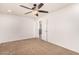 Well-lit bedroom with ceiling fan and access to upper level at 7311 N 90Th Ave, Glendale, AZ 85305