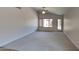 Bright living room with neutral carpeting and access to backyard at 8758 E Obispo Ave, Mesa, AZ 85212