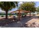 Relaxing covered patio with seating area near tennis courts at 3301 S Goldfield Rd # 3004, Apache Junction, AZ 85119