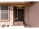 Front entry with a wooden door and security gate at 3301 S Goldfield Rd # 3004, Apache Junction, AZ 85119