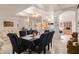 Bright dining room with a table for six, open to the kitchen and living room at 3301 S Goldfield Rd # 3004, Apache Junction, AZ 85119