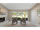 Relaxing sitting area with fireplace and large windows overlooking the backyard at 6516 E Maverick Rd, Paradise Valley, AZ 85253