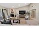 Living room with a large TV, fireplace, and comfortable seating at 6516 E Maverick Rd, Paradise Valley, AZ 85253