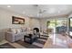 Bright living room features a cozy sofa, fireplace, and sliding glass doors leading to the backyard at 6516 E Maverick Rd, Paradise Valley, AZ 85253