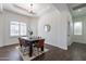 Light and airy dining room with wood table and leather chairs near a window at 2820 E Ranch Ct, Gilbert, AZ 85296