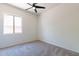 Bright bedroom with neutral carpeting and ceiling fan at 2820 E Ranch Ct, Gilbert, AZ 85296