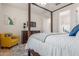 Bedroom with a four-poster bed and ensuite bathroom at 183 W Evergreen Pear Ave, Queen Creek, AZ 85140