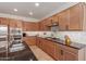 Spacious kitchen with stainless steel appliances and granite countertops at 183 W Evergreen Pear Ave, Queen Creek, AZ 85140