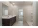 Bathroom boasts double vanity, large mirror, and shower stall at 24635 W Concorda Dr, Buckeye, AZ 85326