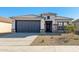 One-story home with gray-toned exterior, two-car garage, and desert landscaping at 24635 W Concorda Dr, Buckeye, AZ 85326