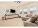 Bright living room featuring a sectional sofa and large TV at 5223 W Encanto Verde --, San Tan Valley, AZ 85144