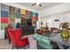 Living room boasts a colorful accent wall, comfortable seating, and a large TV at 10020 E Strobe Ave, Mesa, AZ 85212