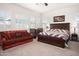 Main bedroom with king-size bed, couch, and plenty of natural light at 10020 E Strobe Ave, Mesa, AZ 85212