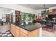 Open kitchen features a large island with seating and dark granite countertops at 10020 E Strobe Ave, Mesa, AZ 85212