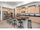Large kitchen island with seating, light wood cabinets, and granite countertops at 10020 E Strobe Ave, Mesa, AZ 85212