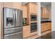 Bright kitchen with stainless steel appliances and light wood cabinets at 10020 E Strobe Ave, Mesa, AZ 85212