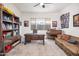 Home office with large desk, piano, and comfortable couch at 10020 E Strobe Ave, Mesa, AZ 85212