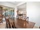 Spacious dining room with large wooden table and access to backyard patio at 10020 E Strobe Ave, Mesa, AZ 85212