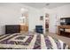 Main bedroom with king bed, sitting chair, and access to bathroom and hallway at 10020 E Strobe Ave, Mesa, AZ 85212