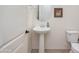 Clean and bright half bathroom with pedestal sink and toilet at 10020 E Strobe Ave, Mesa, AZ 85212