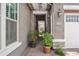 Pathway leads to front door, flanked by potted plants and brick wall accents at 10020 E Strobe Ave, Mesa, AZ 85212