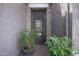 Ornate metal gate opens to a courtyard entry with brick accents and potted plants at 10020 E Strobe Ave, Mesa, AZ 85212