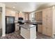 Modern kitchen with light wood cabinets and dark countertops at 8865 E Baseline Rd # 753, Mesa, AZ 85209