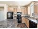 Modern kitchen with dark countertops and black appliances at 8865 E Baseline Rd # 753, Mesa, AZ 85209