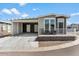 Mobile home with carport, modern exterior, and small front yard at 8865 E Baseline Rd # 753, Mesa, AZ 85209
