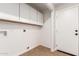 Laundry room with white cabinets and tile floor at 3117 E Escuda Rd, Phoenix, AZ 85050